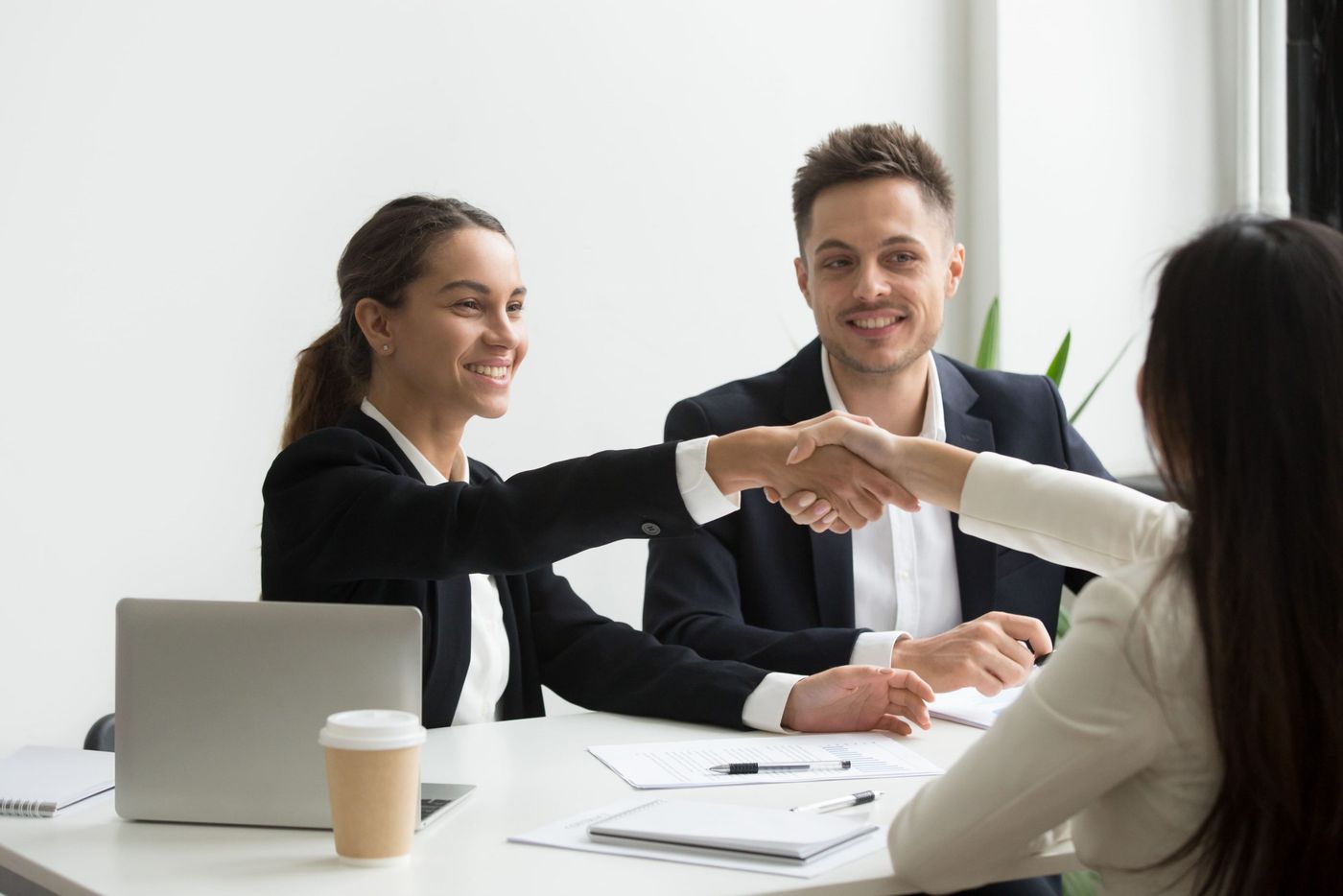 Recruiters shaking hands with a candidate during an interview